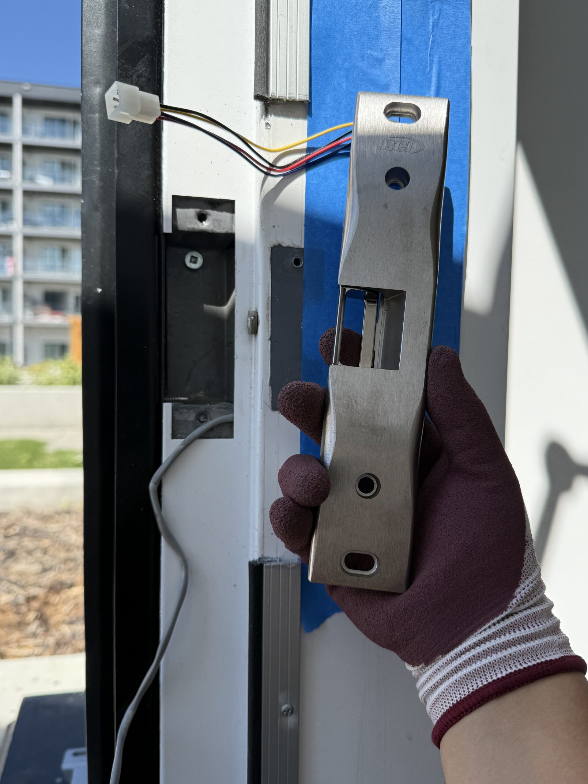 Electric strike installation at a commercial door
